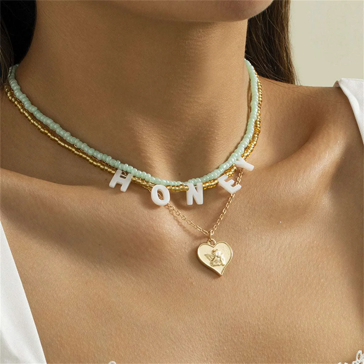 World-Class Howlite Acrylic Goldtone 'Honey' Angel Heart Pendant Necklace Set Flexible
